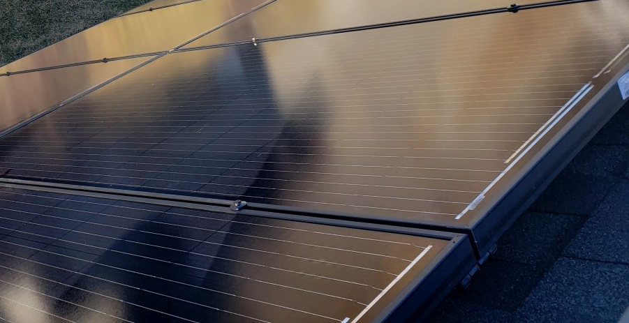 Up close, you can see the texture of the inner-workings of a solar panel. The sleek black finish reflects some surrounding light.